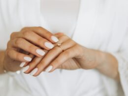 Close-up bride hands touching wedding ring at home