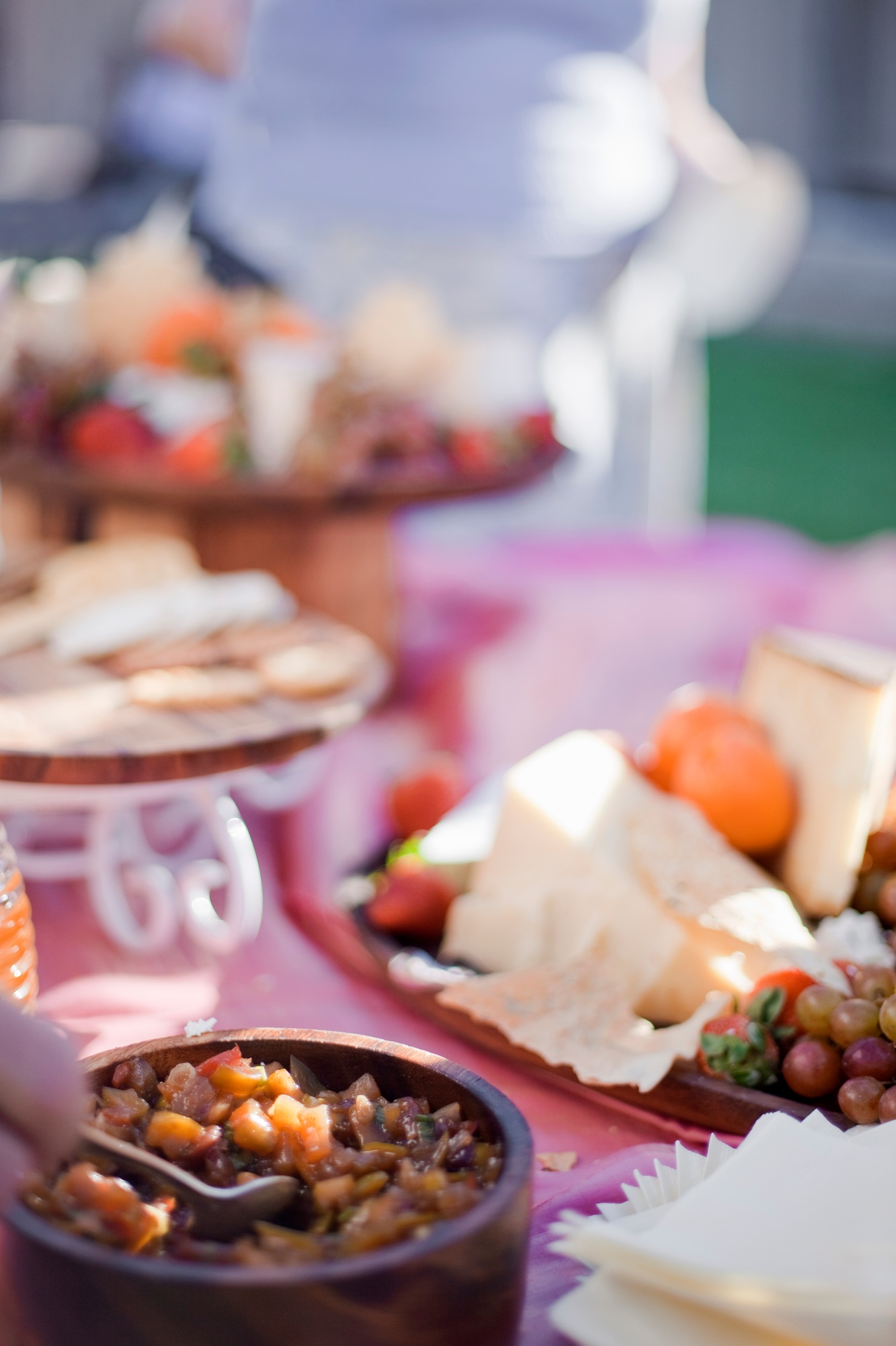 A table laid with a buffet selection of food dishes. Desserts and cheese board.