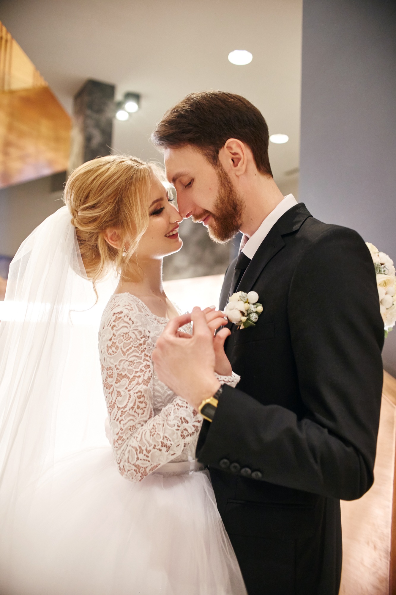 Bride and groom hugging and kissing on their wedding day. Creating a new family, a happy couple in