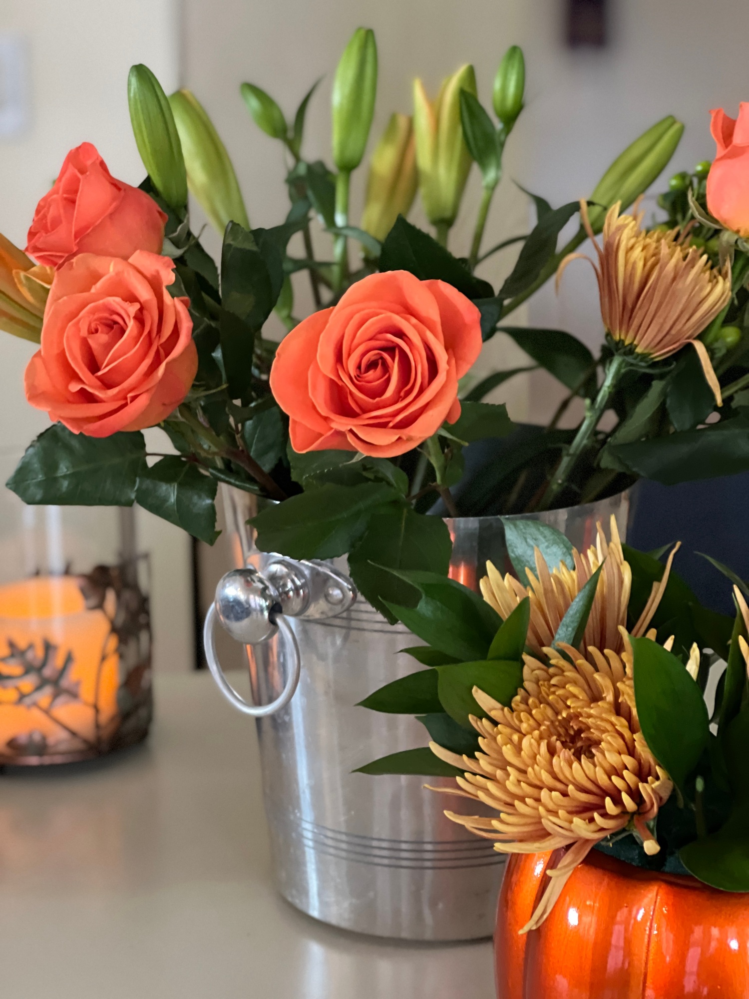 cut flowers in a bucket, preparing to be made into centerpieces for a fall harvest dinner