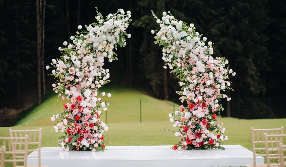 Wedding ceremony on the street on the green lawn.Decor with fresh flowers arches for the ceremony