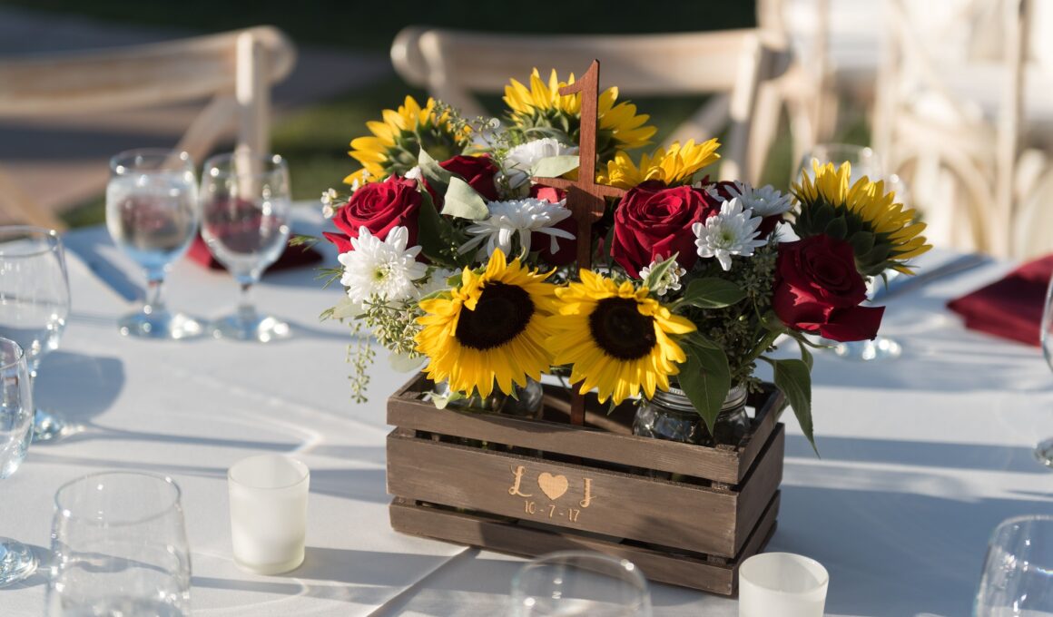 Rustic wedding centerpiece with sunflowers and roses.