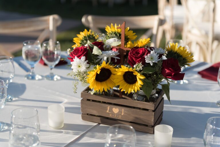 Rustic wedding centerpiece with sunflowers and roses.