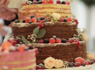 The waiter cuts the wedding cake
