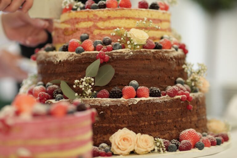 The waiter cuts the wedding cake