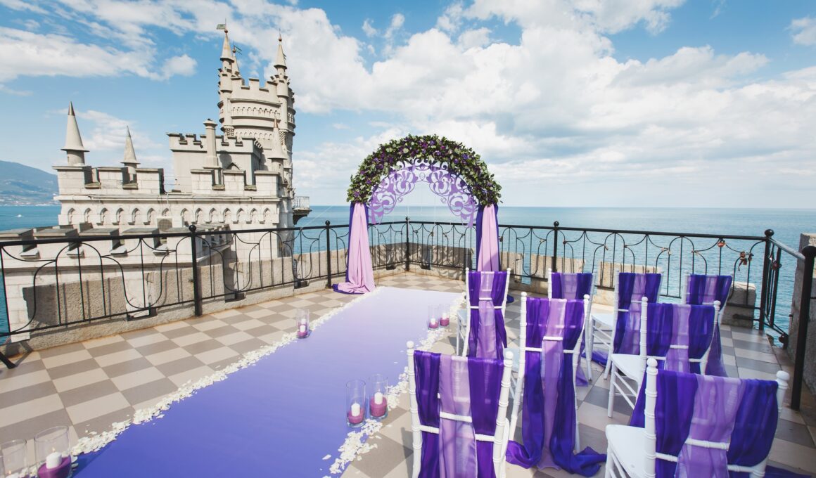 Wedding arch of purple color on the background of the sea.