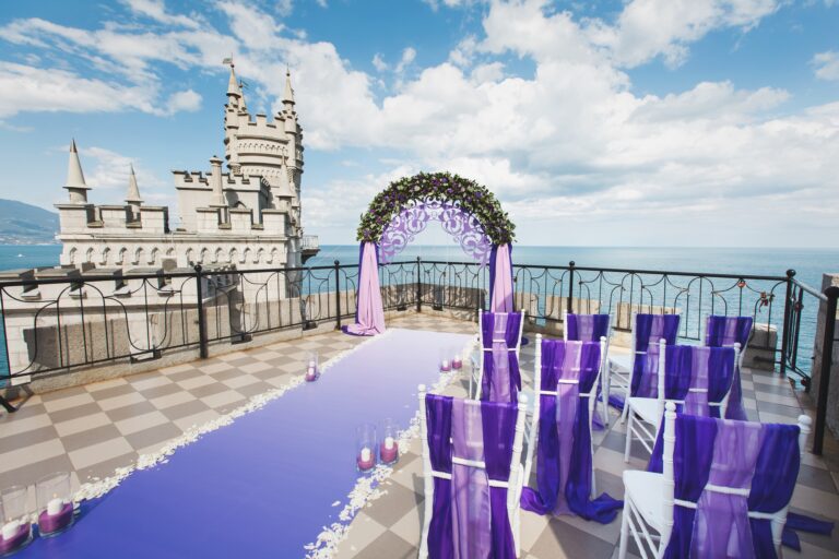 Wedding arch of purple color on the background of the sea.