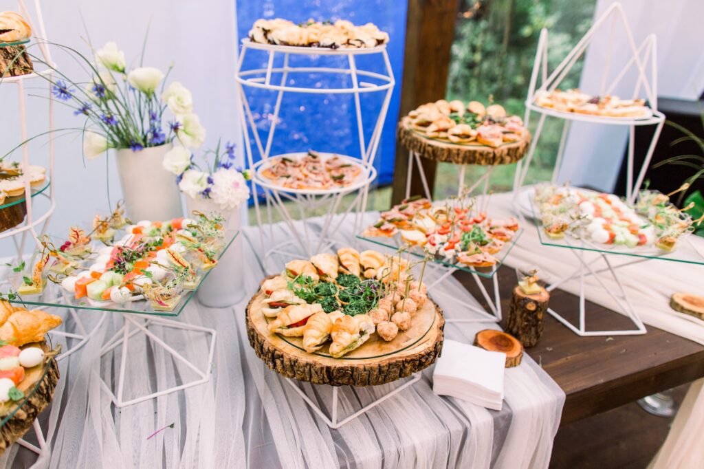 Catering buffet and rustic decor, outdoor wedding party with healthy food snacks