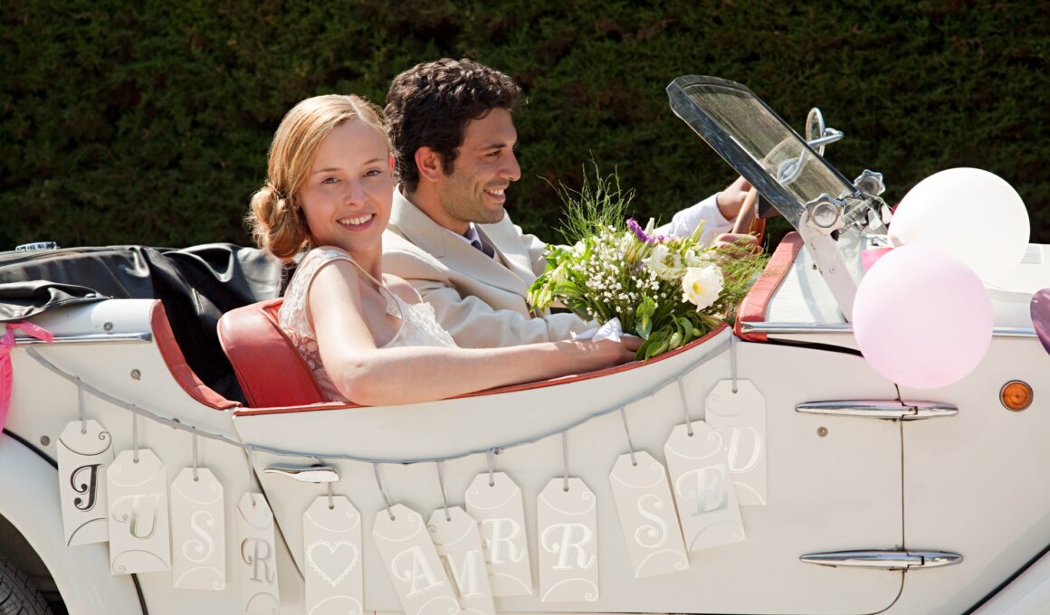 Newlyweds leaving for honeymoon in vintage car