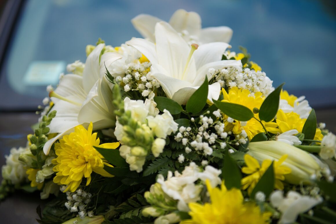 Wedding car decor with white and yellow lilies flowers