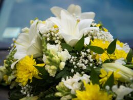 Wedding car decor with white and yellow lilies flowers