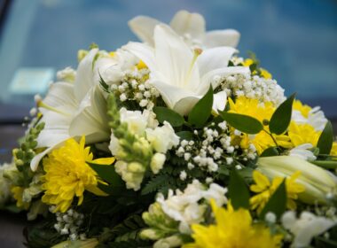 Wedding car decor with white and yellow lilies flowers
