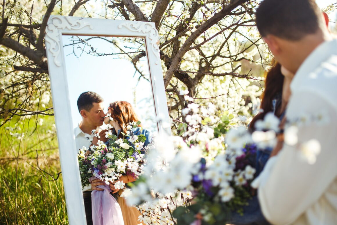 Beautiful loving couple in blooming gardens. Wedding concept. Great sunset light. Lovely newlyweds.
