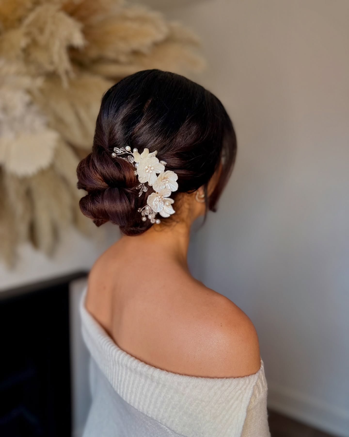 Side Chignon with Sleek Flowers