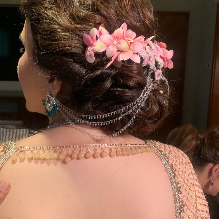 Low Sleek Bun with Rose Cluster