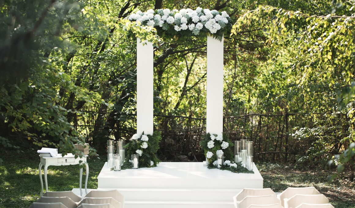 Wedding arch with white flowers and candles
