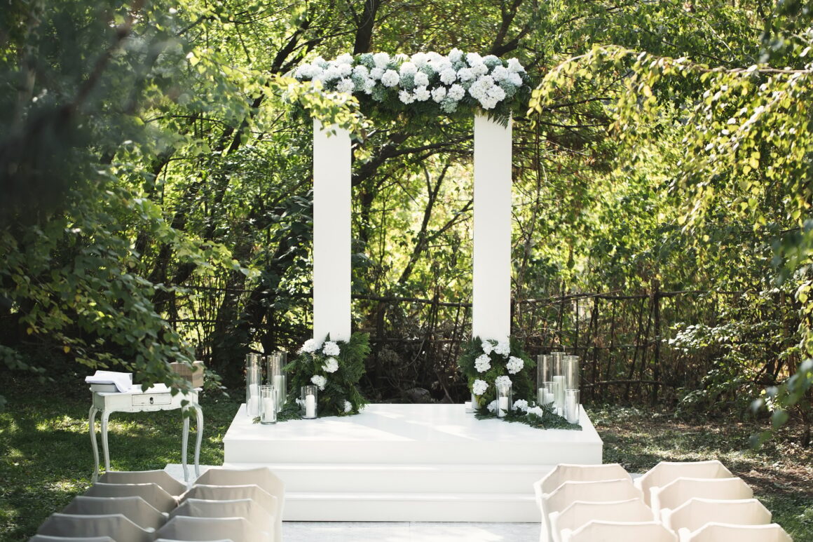 Wedding arch with white flowers and candles