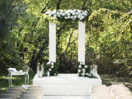 Wedding arch with white flowers and candles
