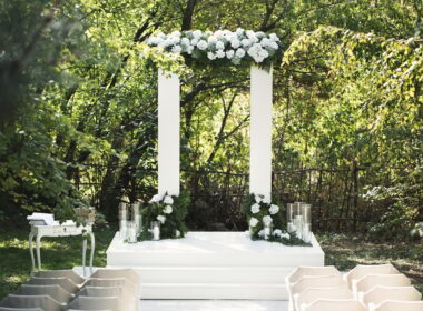 Wedding arch with white flowers and candles