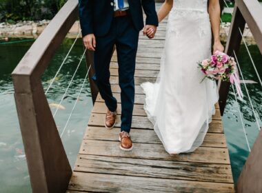 Wedding ceremony near lake. View of the bottom couple newlyweds bride and groom walking along the