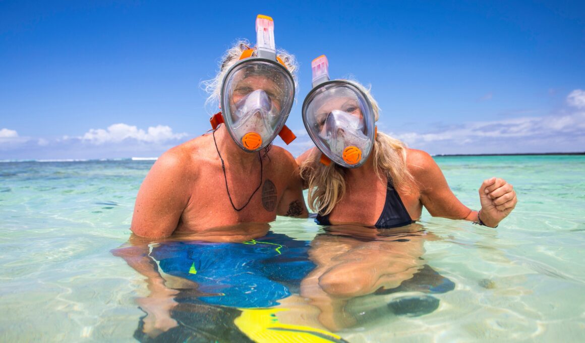 Portrait of mature couple in sea, wearing snorkel, Ile aux Cerfs, Mauritius