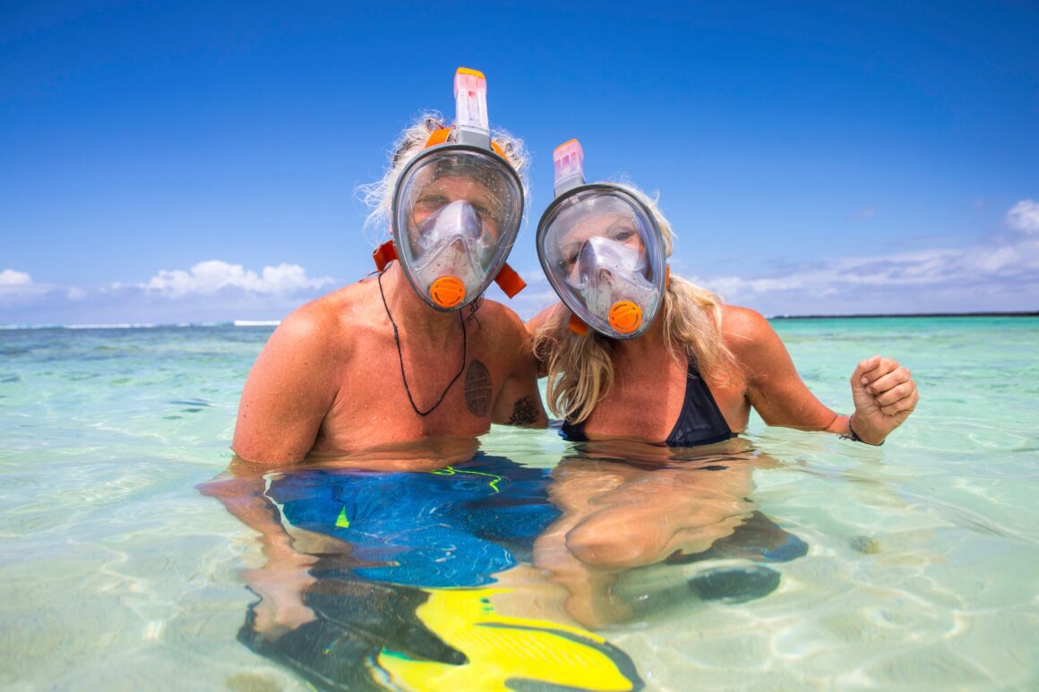 Portrait of mature couple in sea, wearing snorkel, Ile aux Cerfs, Mauritius