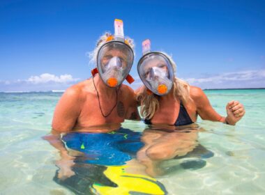 Portrait of mature couple in sea, wearing snorkel, Ile aux Cerfs, Mauritius