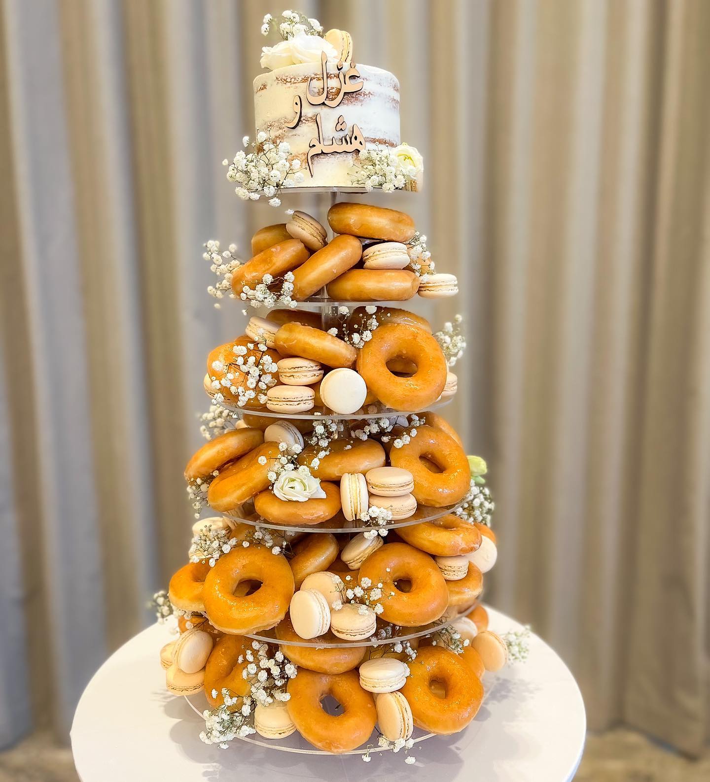 Donut cake topped with macarons and berries