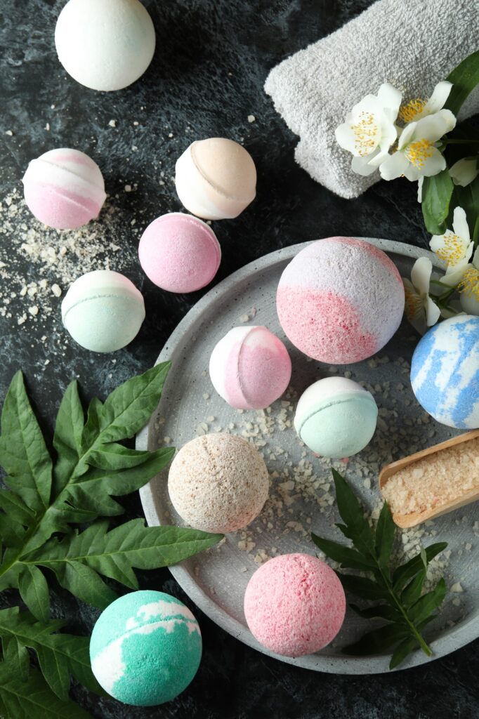 Body care concept with bath balls on black smokey table