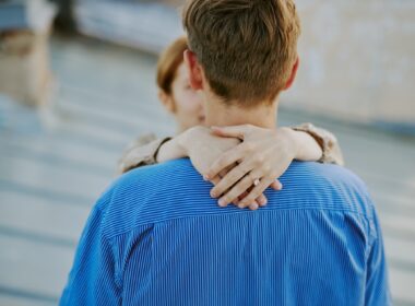 Couple Embracing with Emphasis on Engagement Ring