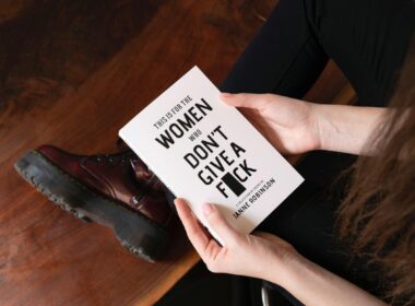 woman holding white book