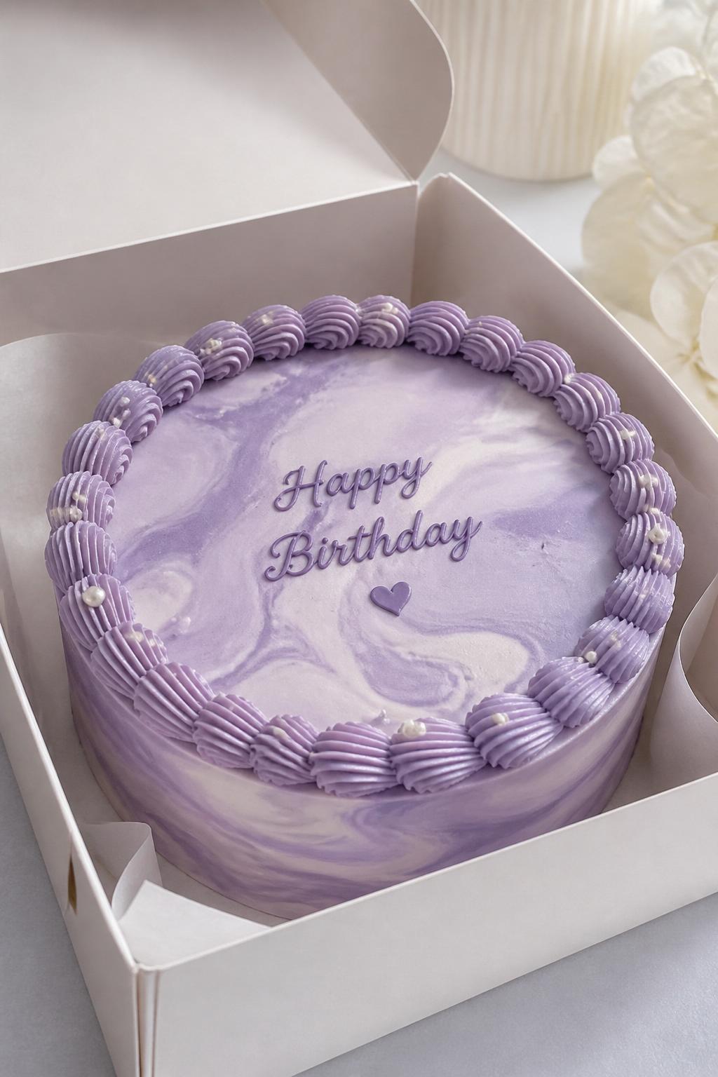 Image Prompt:
A stylish purple marble bento cake inside an open white cake box, smooth buttercream frosting with soft lavender and white marble swirls, neat border, modern elegant styling, clean soft background, realistic close-up bakery photography, no people, no hands, no faces, (no watermarks on images)