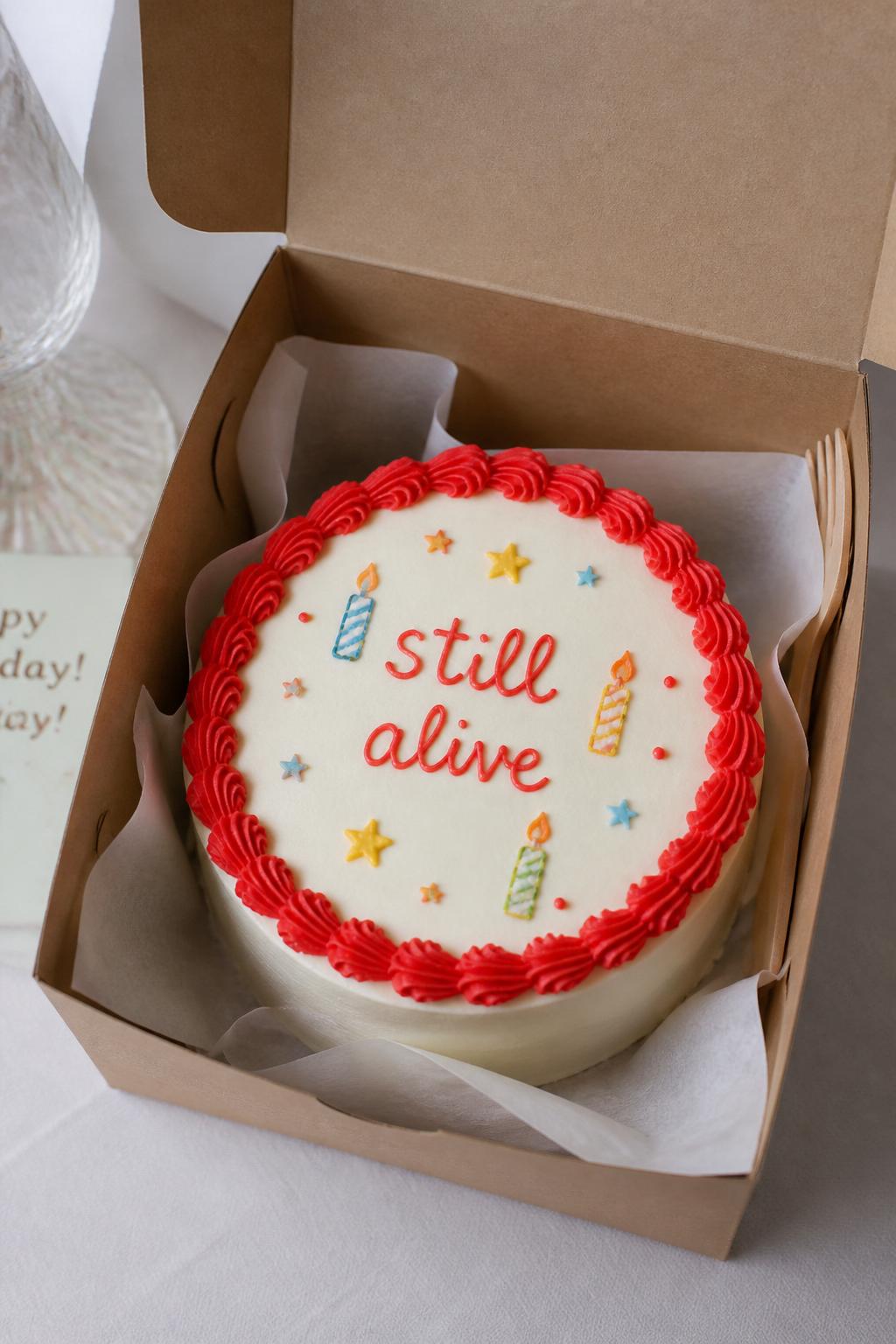 Image Prompt:
A funny birthday bento cake inside an open kraft cake box, smooth white frosting, bold red piped border, handwritten icing text reading “still alive,” tiny candle doodles and star details, playful birthday styling, soft natural light, realistic bakery photography, no people, no hands, no faces, no watermarks on images