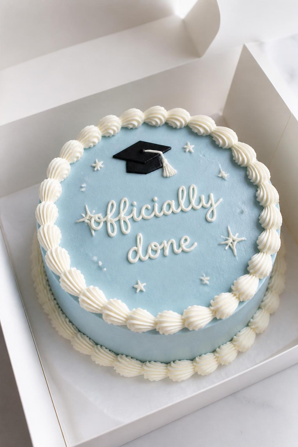 Image Prompt:
A trendy graduation bento cake inside an open white cake box, smooth pale blue frosting, neat white piped border, handwritten icing text reading “officially done,” tiny sparkles and star accents, modern fun styling, bright clean backdrop, realistic bakery photography, no people, no hands, no faces, (no watermarks on images)