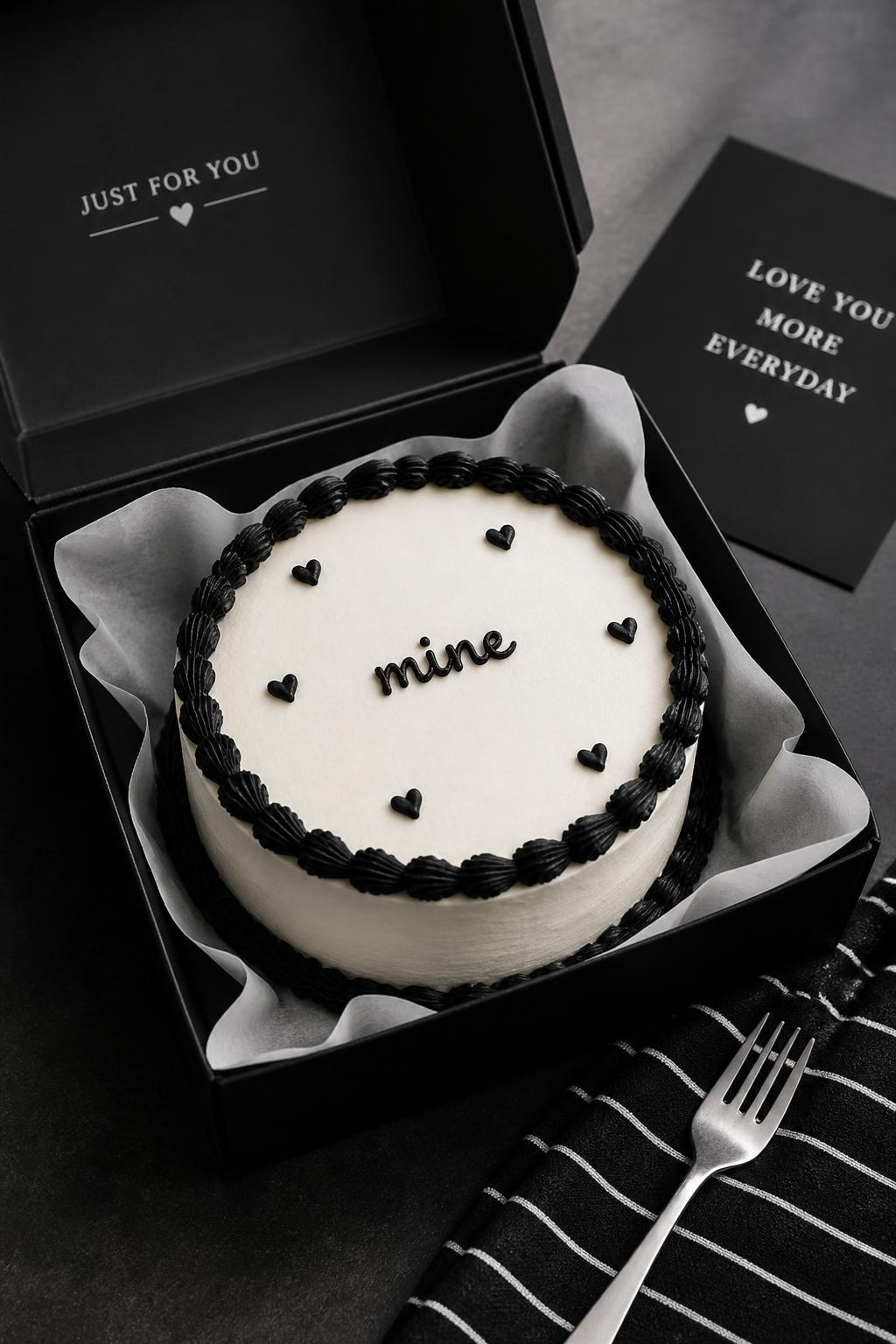 Image Prompt:
A stylish black and white bento cake for boyfriend inside an open black cake box, smooth white frosting, black piped border, small black heart details, short icing text reading “mine,” sleek modern dessert styling, monochrome napkin, silver mini fork, clean editorial food photography, soft studio light, masculine romantic aesthetic, no people, no hands, no faces, no watermarks on images