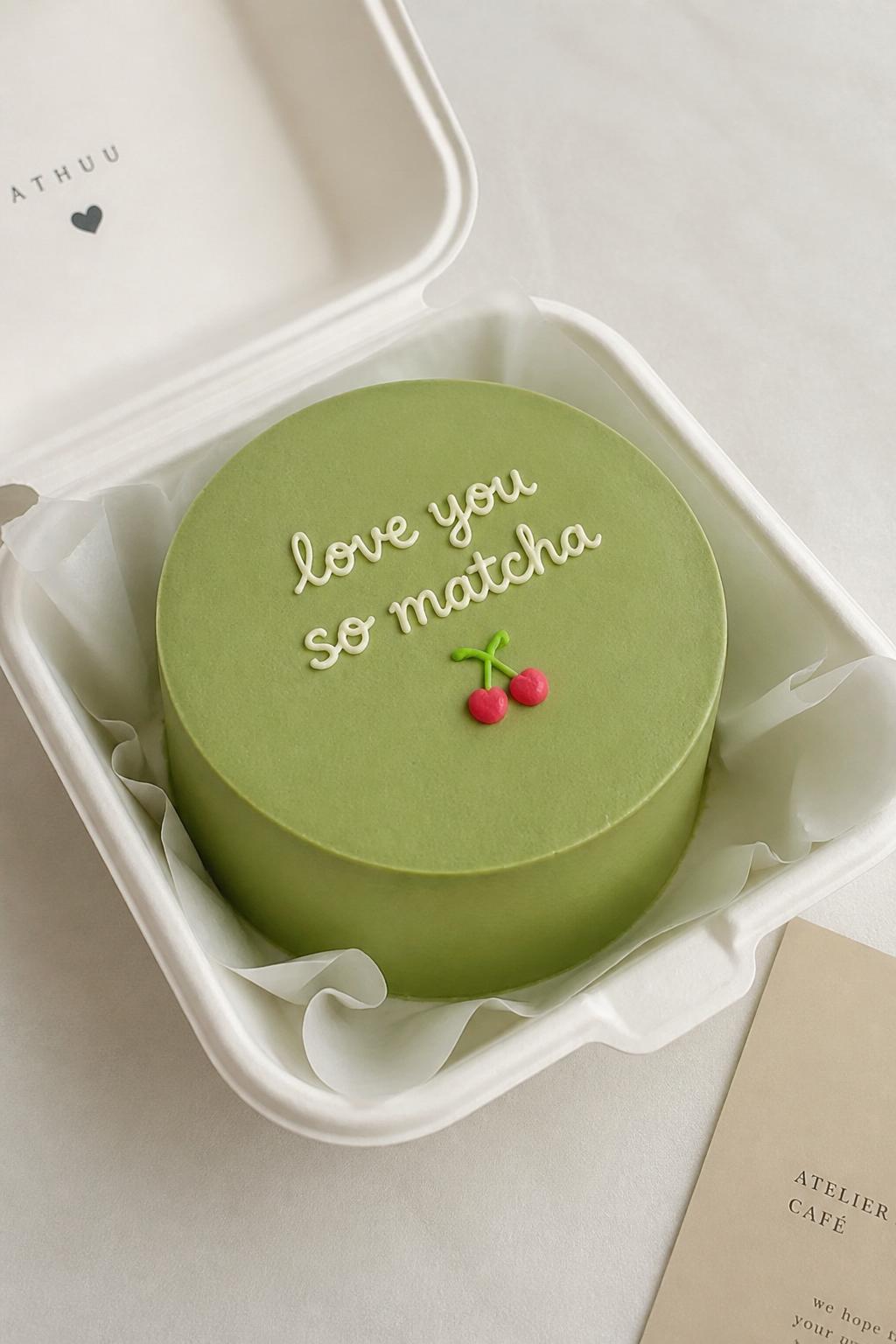 Image Prompt:
A modern Korean style green bento cake in a white cake box, smooth pale matcha green frosting, clean finish, tiny cherry or heart detail, simple handwritten icing message, minimal cute styling, soft neutral background, realistic editorial bakery photo, no people, no hands, no faces, no watermarks on images