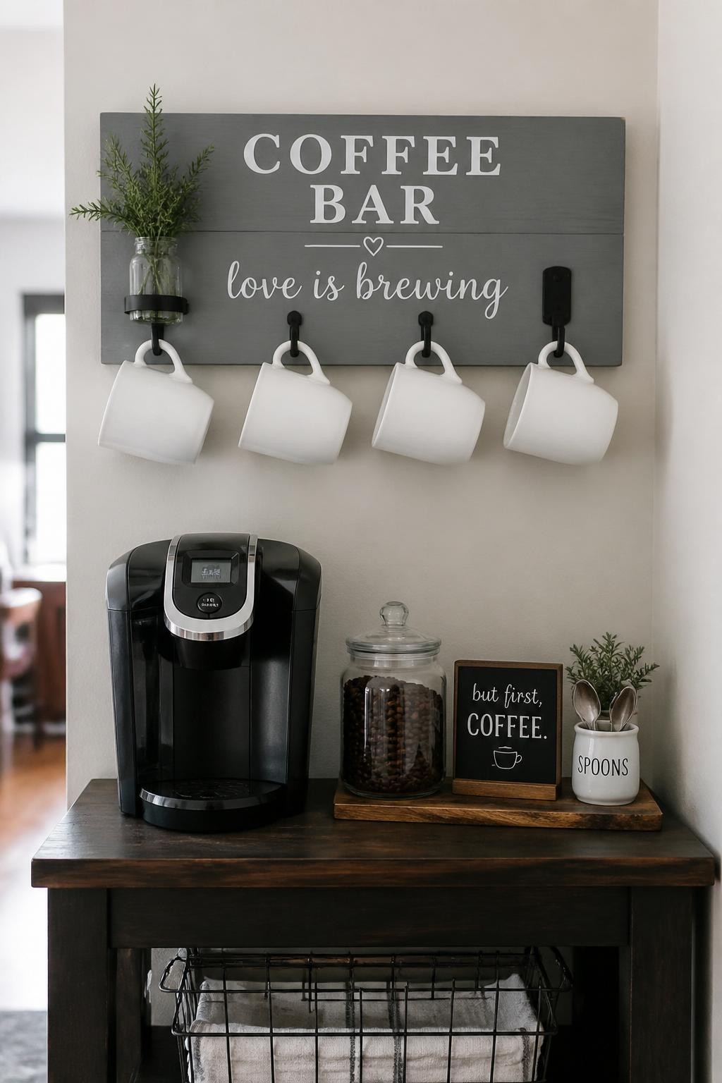 A realistic DSLR photo of a small DIY coffee bar wall with a painted wooden board and simple hooks holding white mugs, compact coffee machine on a narrow table below, glass jar of coffee beans, tiny tray of spoons, small coffee sign, soft natural light, cozy farmhouse-inspired budget decor, no people.