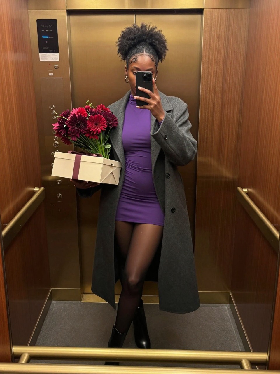 Image Prompt: A polished but realistic mirror photograph of a young Black woman inside a wood-paneled hotel elevator with warm brass details. She wears a long charcoal coat over a fitted plum mini dress, sheer black tights, and pointed ankle boots. Her natural hair is styled in a high textured puff. She carries a small cream cake box in one hand and a bouquet of dark red flowers in the other. Her phone covers part of her face while she angles one knee inward and turns her shoulders slightly toward the mirror. Natural deep brown skin tone, believable reflections, subtle fingerprints on the brass panel, visible coat and flower textures, current birthday-night fashion aesthetic.