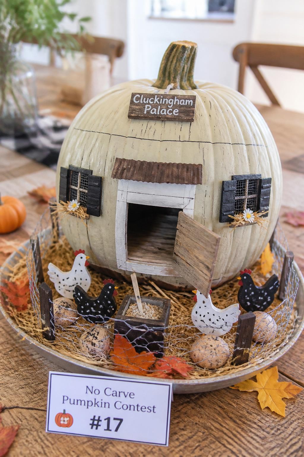 Image Prompt: A realistic DSLR photo of a medium pumpkin decorated as a tiny chicken coop, with painted wooden plank lines, small paper coop door, mini chicken cutouts, faux straw, tiny eggs, wire-style craft mesh, autumn leaves, and a rustic farmhouse table setting, bright natural daylight, detailed no-carve pumpkin contest display.