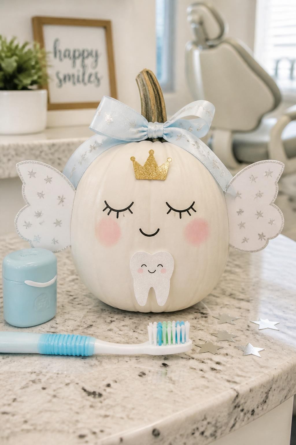 Image Prompt: A realistic DSLR photo of a white medium pumpkin decorated as a cute tooth fairy, with soft painted eyelashes, blush cheeks, a tiny gold crown, white paper wings, a small smiling tooth cutout on the front, pastel blue ribbon around the stem, and silver star confetti, displayed on a clean dental office counter with a toothbrush, floss container, and warm natural light, adorable no-carve pumpkin craft.